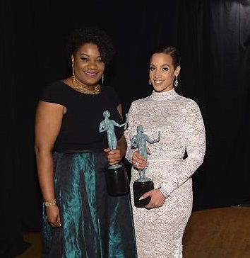 Adrienne C. Moore holding award